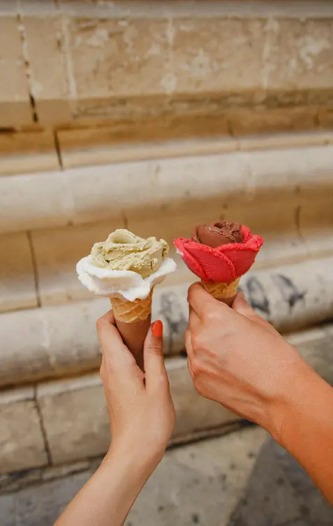 Two people holding icecream cones