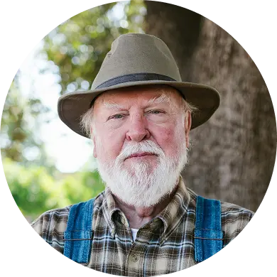 A man wearing overalls and a hat