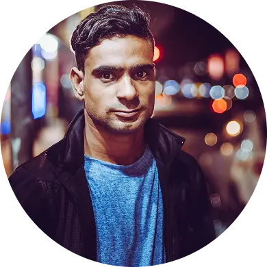 A man with city lights behind him